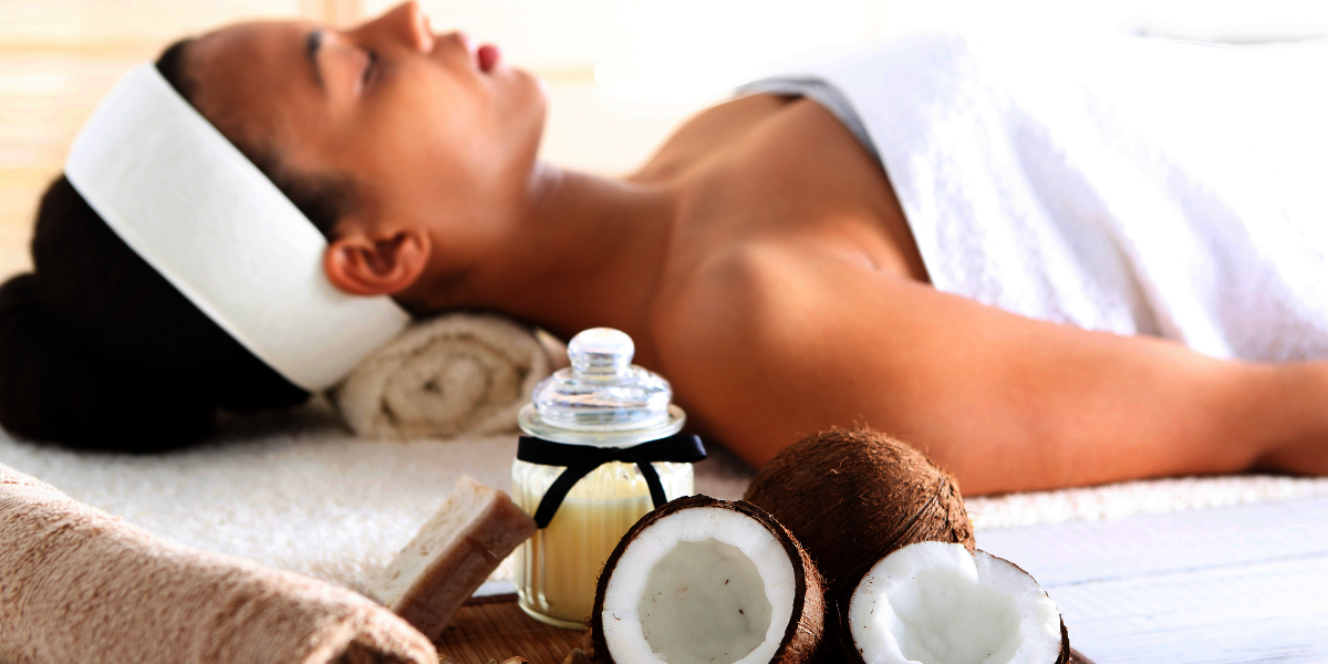 Frau liegend auf einem Handtuch neben ihr ätherische Öle Massage 